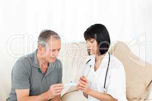 Nurse showing pills to her patient