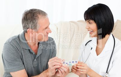 Nurse showing pills to her patient