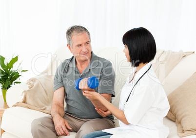 Nurse helping her patient to do exercises