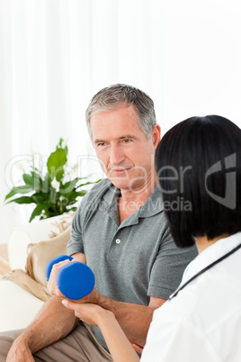 Nurse helping her patient to do exercises