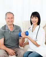 Nurse helping her patient to do exercises