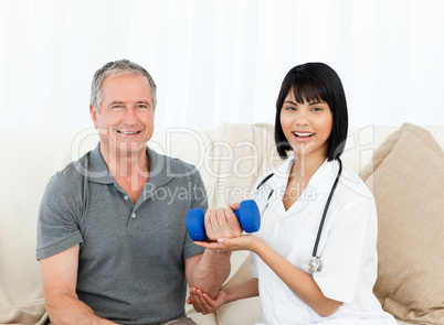 Nurse helping her patient to do exercises