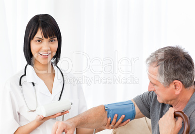 Nurse taking blood pressure of her patient