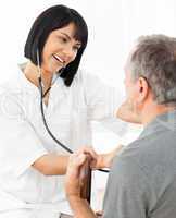 Senior laughing with his nurse