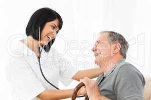 Senior laughing with his nurse