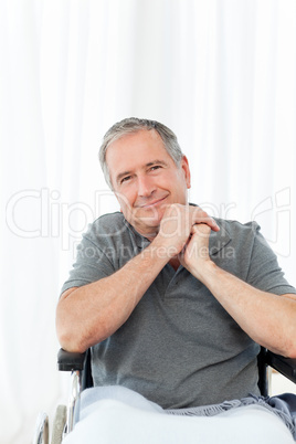 Senior in his wheelchair looking at the camera