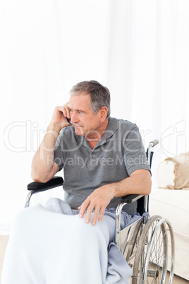 Senior in his wheelchair phoning