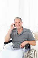 Senior in his wheelchair phoning