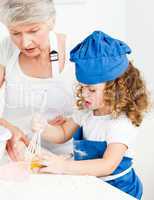 A little girl  baking with her grandmother