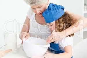 A little girl  baking with her grandmother