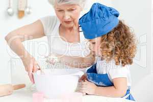 A little girl  baking with her grandmother
