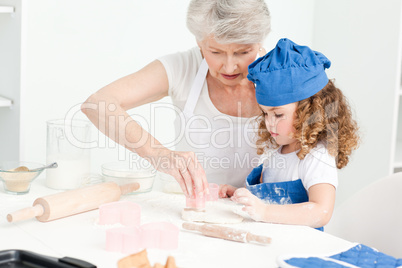 A little girl  baking with her grandmother