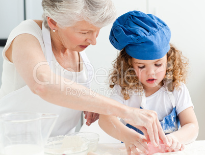 A little girl  baking with her grandmother