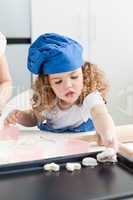 A little girl  baking with her grandmother