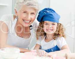 A little girl with her grandmother looking at the camera