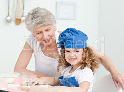 A little girl with her grandmother looking at the camera
