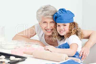 A little girl with her grandmother looking at the camera