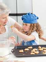 A little girl baking with her grandmother