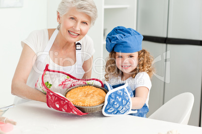 A little girl with her grandmother looking at the camera