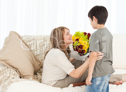 Boy offering flowers to his grandmother