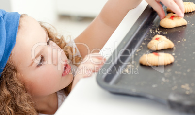 Little girl stealing cookies