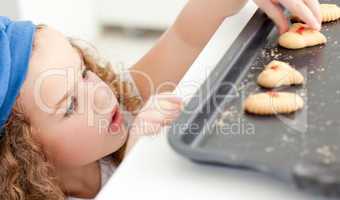 Little girl stealing cookies