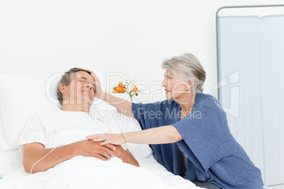 Mature woman taking care of her husband