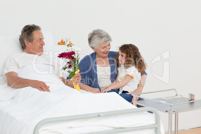 A little girl talking  with her grandparents