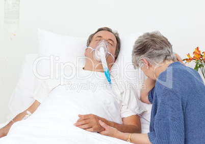 Sad retired woman with her husband in a hospital