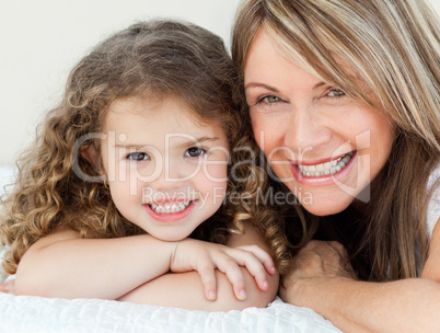 Little girl with her grandmother looking at the camera