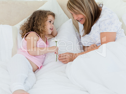 Little girl offering a gift to her grandmother