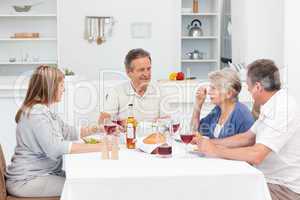 Mature friends taking lunch together