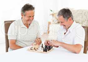 Seniors playing chess on the table