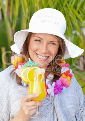 Retired woman drinking a cocktail under the sun