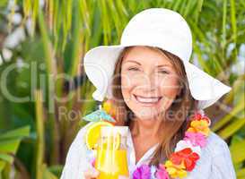 Retired woman drinking a cocktail under the sun