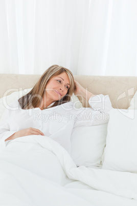 Mature woman  lying down in her bed