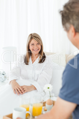 Man bringing breakfast to his wife