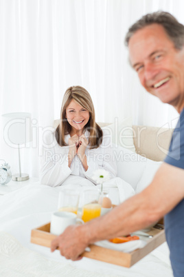 Man bringing breakfast to his wife