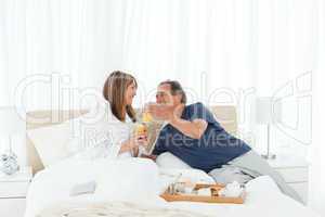Lovely couple having breakfast in their bed