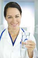 Smiling Woman Doctor in Hospital Holding Glass of Water