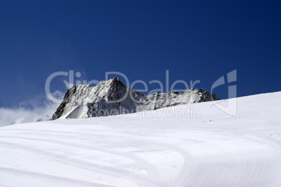 Ski slope against mountain peaks