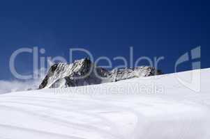 Ski slope against mountain peaks