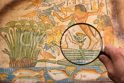 magnifying glass on antique papyrus