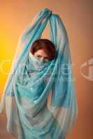 Woman in arabian costume hide face with veil