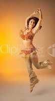 woman jump in dance with finger cymbals