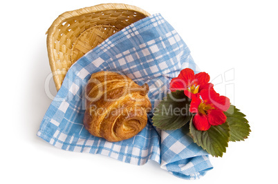Croissant with a basket and flowers