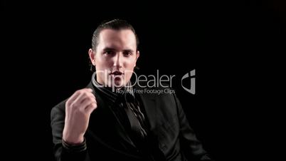 businessman speaks on black background