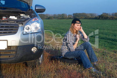 Young Blond Woman With Her Broken Car