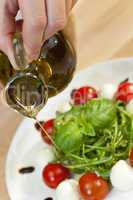 Olive Oil Dressing on Tomato Mozzarella Rocket & Basil Salad
