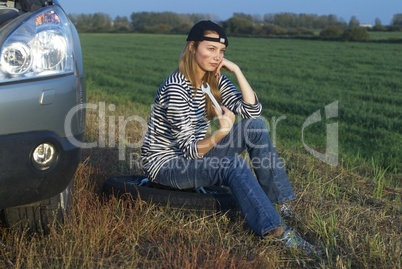 Young Blond Woman With Her Broken Car